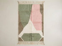 Custom made Beni Ourain Moroccan wool rug featuring geometric diamond patterns in soft sage green, powder pink, white, and earthy taupe with traditional fringe.