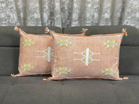 orange Handwoven Moroccan pillow with colorful Berber patterns