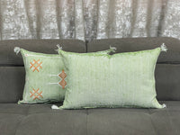 green Handwoven Moroccan pillow with colorful Berber patterns