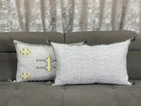 Handwoven Moroccan pillow with colorful Berber patterns
