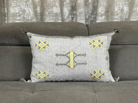 Handwoven Moroccan pillow with colorful Berber patterns