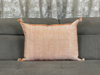 orange Handwoven Moroccan pillow with white Berber patterns