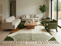A large, custom-sized earthy geometric Moroccan rug anchoring a contemporary living room with a neutral linen sofa and wooden coffee table.