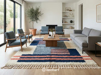 Large custom Moroccan area rug in a modern bohemian living room setting, anchored under a neutral linen sofa and reclaimed wood coffee table, highlighting the blue diamond motif.