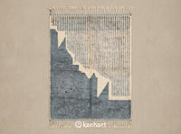 Custom made to order Beni Ourain Moroccan rug flat lay showing plush cream wool pile with medium density geometric diamond pattern in charcoal and dusty blue grey accents with traditional fringe.