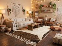 Large custom Beni Ourain area rug in cream and warm browns anchoring a luxury modern living room with a linen sofa and wooden coffee table.