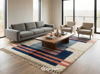 Plush cream and blue Beni Ourain shag rug placed beside a bed in a minimalist bedroom, showing the thick pile and cozy texture.