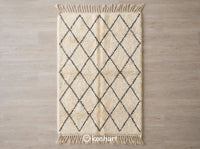 Handwoven Custom Beni Ourain Moroccan Rug with shaggy cream wool pile and charcoal imperfect diamond lattice pattern, showing traditional fringe.