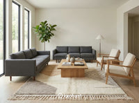 Luxurious custom Moroccan shag rug placed in a minimalist living room setting anchoring a neutral linen sofa and wooden coffee table.
