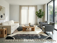 Plush made-to-order Beni Ourain shag rug placed under a king-size bed in a serene, bohemian bedroom setting. Soft white pile with subtle geometric motifs.