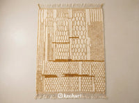 Custom made-to-order Beni Ourain Moroccan wool rug flat lay showing plush cream pile and earthy yellow geometric diamond pattern with traditional fringe